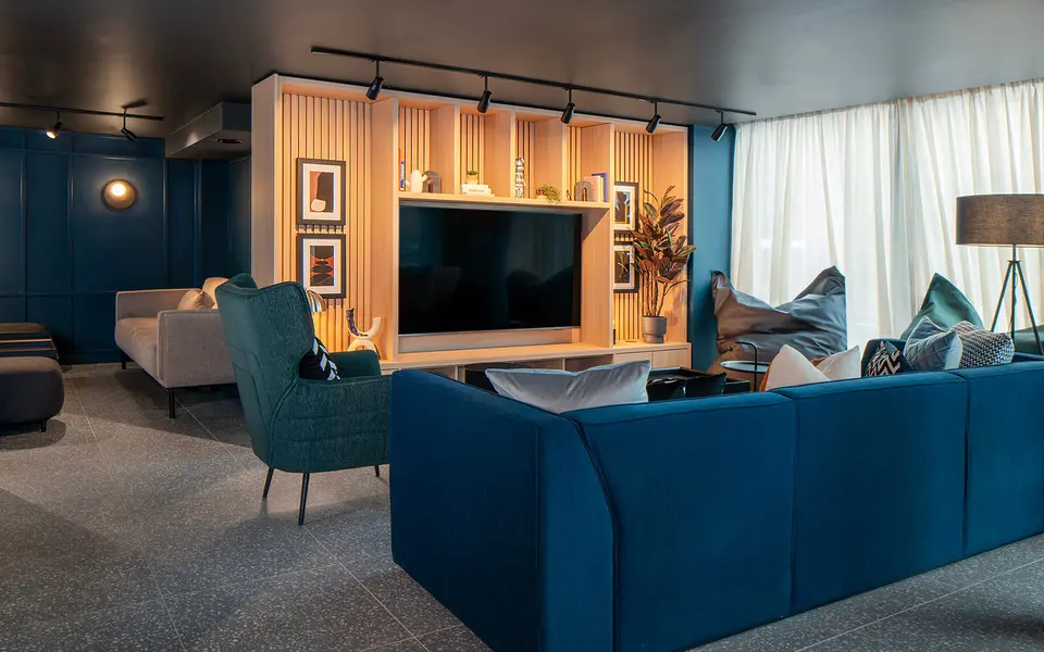 HU Baparthotel Birmingham seating area with a lounge and television